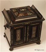  A monumental coromandel ebony compendium table cabinet of architectural form having turned and carved feet and handles. It is profusely inlaid to the top and front with mother of pearl.
 The compendium is the personal space for the owner and has a fully fitted sewing tray complete with its original filigree silver and bone thread spools and other tools, There are two drawers for jewelry, and a folding writing box.
