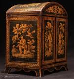 JB633: Rare Penwork table cabinet with curved Regency shape. The penwork depicts exquisite chinoiserie scenes of figures in the fantastical gardens of Cathay. The compartmentalized interior was fitted for jewelry in the 19th Century. The hinged doors open to four drawers with turned bone handles. The upper part was originally fitted for sewing. The divisions retain their original pink lining paper. The domed top and flared skirted base are unusual. A superb piece of its period. Circa 1820
