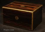JB623: Antique brass edged figured coromandel box with sprung velvet lined drawer  and a lift out tray suitable for storing jewelry.   The box has small veneer repairs.. Working  lever lock and key. Circa: 1870 