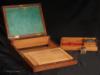 A mahogany brass bound box which is an example of  a combined dressing case and writing desk. The lift out dressing tray is fitted for holding a man's grooming accessories. This is a very unusual arrangement.  This box is very similar to another box on our site. The two must have come from the same workshop. Characteristic features of this box such as the particular shape of the protective corners, flat side handles, shape of central plaque, and quality of wood and workmanship, strongly point to the work of the cabinet maker Middleton who was recorded as working from 1801-10 at 162 Strand, London.  