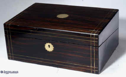 WB172: A coromandel writing box, the front and top inlaid with brass, the sides and back ebonized, opening to a fitted interior with embossed leather writing surface, and compartments for paper and writing instruments, Circa 1860.  Enlarge Picture