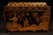 TC533: A two compartment penwork tea caddy with quirky exotic scenes depicting imagined eastern figures in the land of Cathay. The cavetto  molding is decorated with repeating palmette in a fluid hand more suited to the overall design  of the caddy than the more rigid neo classical . Inside there are two lidded compartments still  retaining remnants of their original leading. The caddy retains its original hardware such as hinges lock and embossed brass ring handles in the form of baskets of flowers. circa 1830. Enlarge Picture