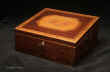 An early 19th century partridgewood writing box with inlaid banding and decorated with a hand coloured engraving depicting a winged Victory ahead of a Classical laurelled hero riding in his chariot. The box has side carrying handles a drawer, inner velvet writing surface and places for writing materials and accessories. Enlarge Picture