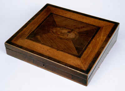A writing slope veneered in mahogany. The whole top is framed in pear wood. The center with an oval of burr yew, crossbanded in mahogany. A symmetrical effect in the neoclassical tradition is achieved by the juxtaposition of timbers, grain, and figure. A subtle piece of inspired craftsmanship, the design belies the complexity of the work. Typical of the school of understated quality of the Georgian period. 